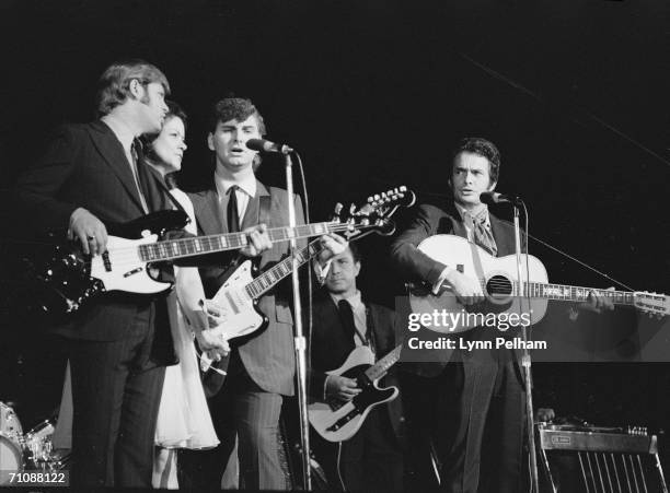 American country music performer Merle Haggard performs on stage with his band, 1970.