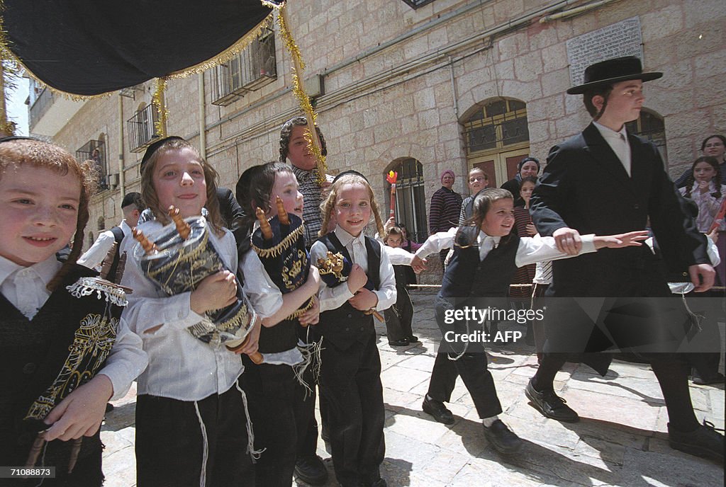 Ultra Orthodox children march with Torah