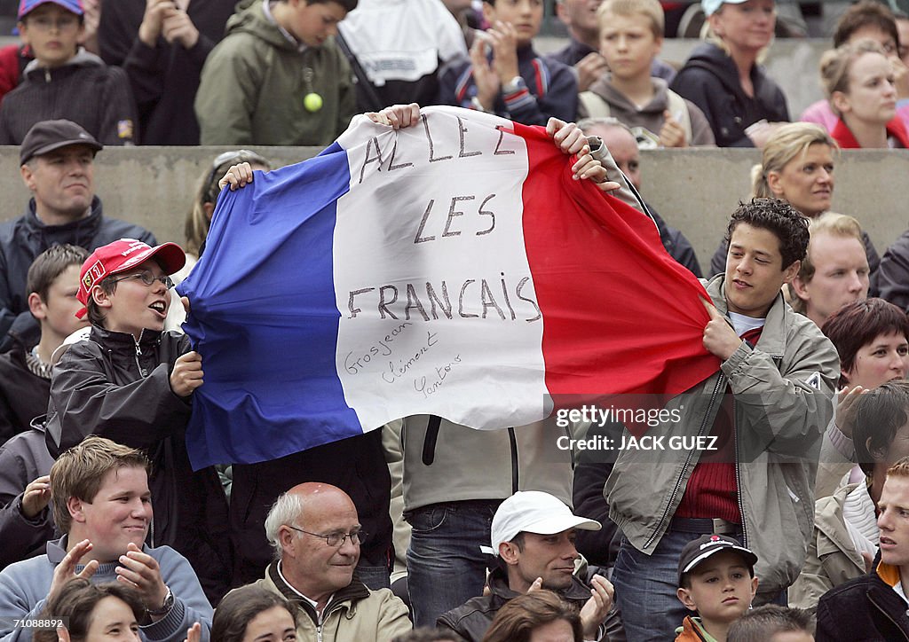 French supportes hold a flag during the