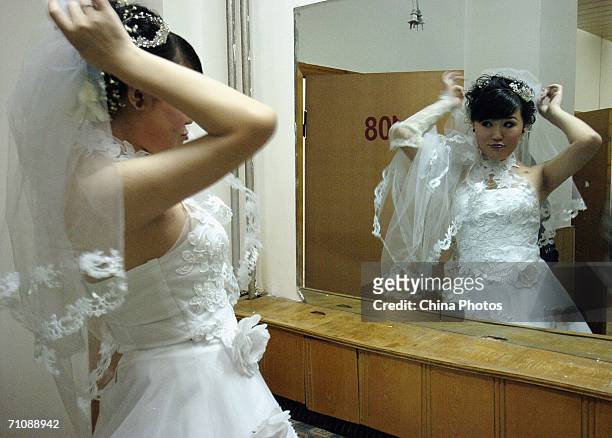 Transsexual Xinr prepares before her wedding reception on May 19, 2006 in Changchun, China. Once a man, 24-year-old Xinr underwent a sex-change...