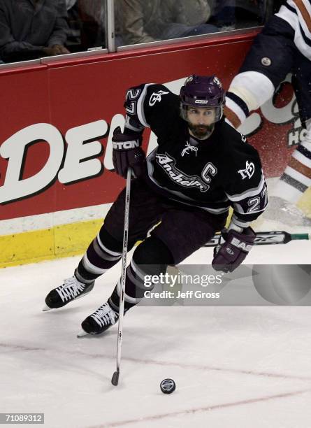 Scott Niedermayer of the Mighty Ducks of Anaheim skates the puck from behind the net during game five of the NHL Western Conference Finals against...