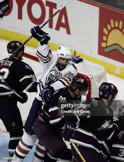 Radek Dvorak of the Edmonton Oilers celebrates in the crease area in the midst of Mighty Ducks defenders after teammate Ethan Moreau scored in the...