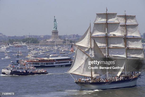 Water vessels, including a tugboat , a Circle Line sightseeing vessel, and a square-rigged sailing ship, the Scottish-built, iron-hulled,...