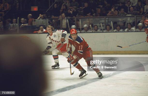 Russian professional hockey player Valeri Kharlamov , forward for the CSKA Moscow Soviet Wings, skates on the ice followed closely by Canadian hockey...