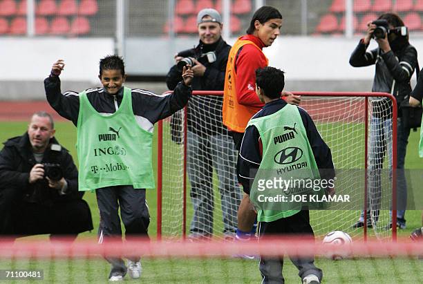 Prague, CZECH REPUBLIC: Czech international Aston Villa striker Milan Baros looks on during an exhibition match with kids from various orphaneges in...