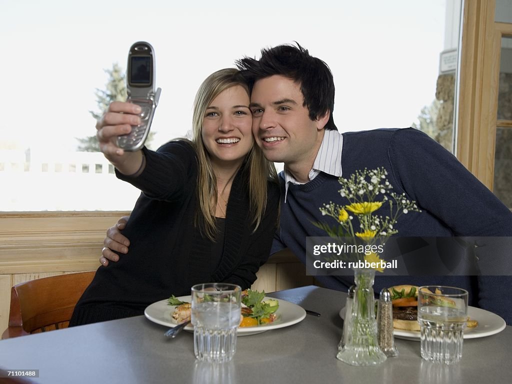 Young couple taking a photograph of themselves