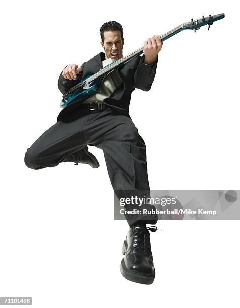 low angle view of a businessman playing the guitar - bass guitar stock pictures, royalty-free photos & images