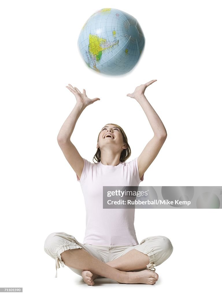 Girl playing with a globe