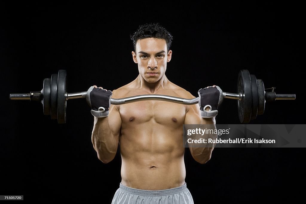 Portrait of a mid adult man lifting a barbell