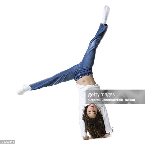 portrait of a girl doing a cartwheel - girl upside down stock pictures, royalty-free photos & images