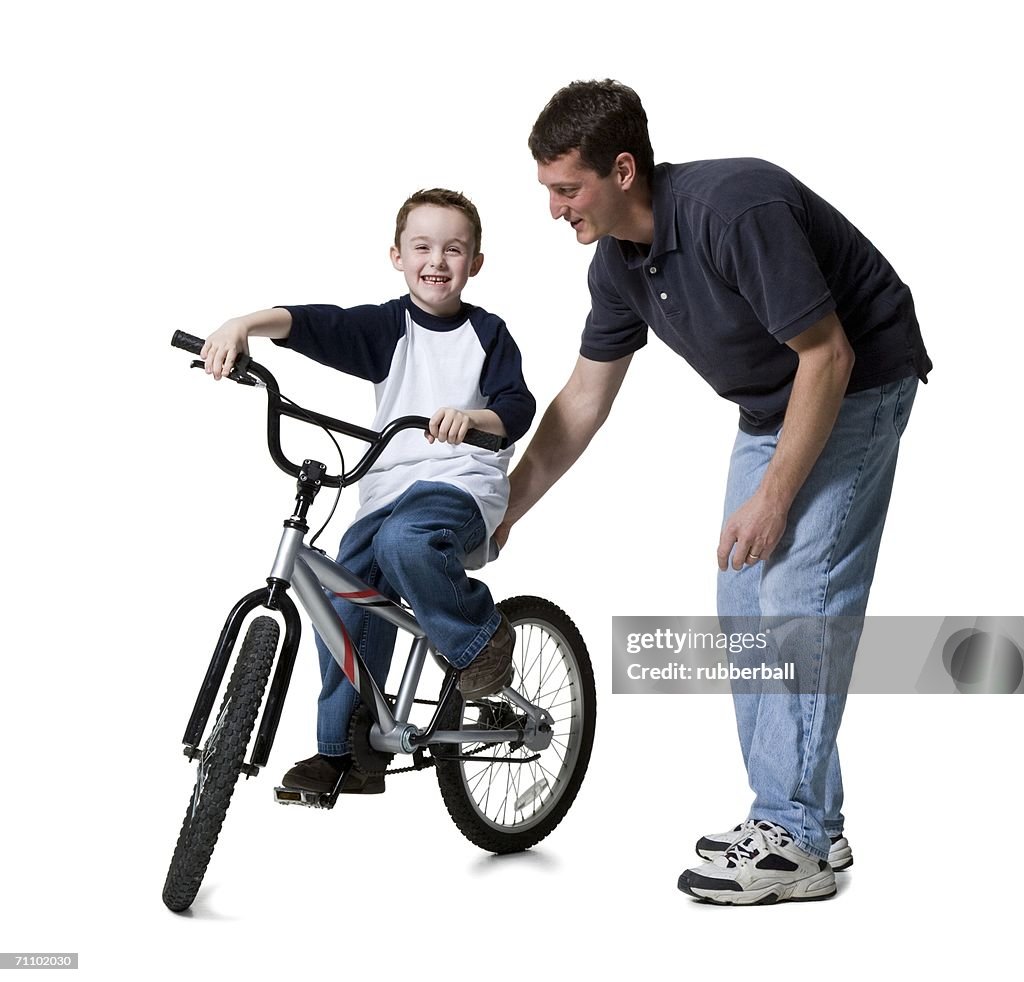 Father teaching his son to ride a bicycle