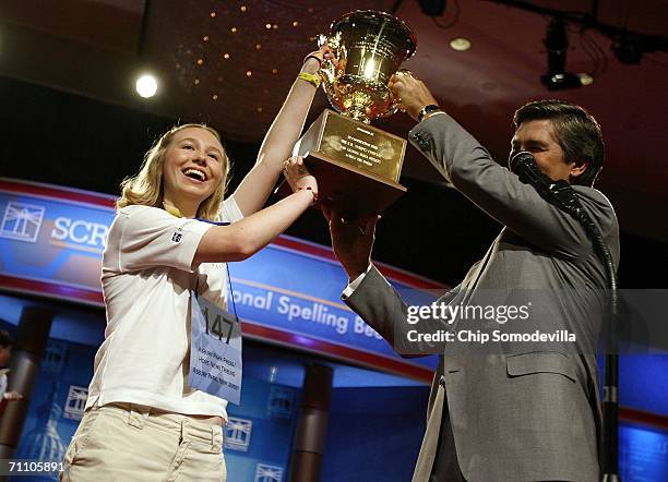 Katharine Close of Spring Lake, New Jersey, gets a hand from EW Scripps Company CEO Ken Lowe while holding up the championship trophy after winning...