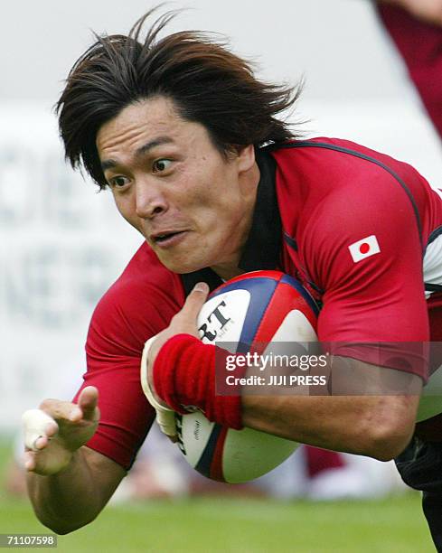 Japanese right winger Daisuke Ohata dives to make his record try in a test match series against Georgia in the Hanazono rugby stadium in Higashi...