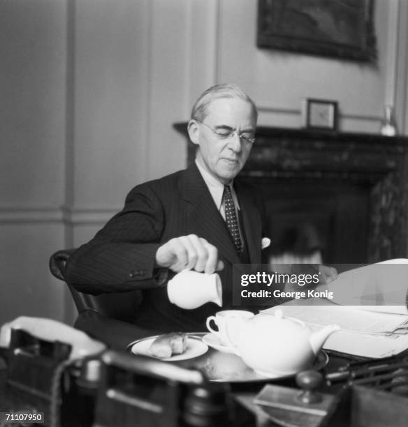 British Chancellor of the Exchequer Sir Stafford Cripps pours a cup of tea in his office, 16th February 1949.