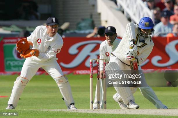 Nottingham, UNITED KINGDOM: Sri Lankan batsman Charminda Vaas defends his wicket from the bowling of England's Monty Panesar against England during...