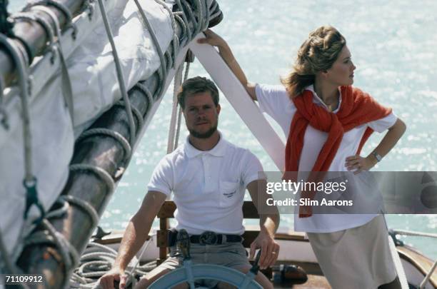 Matthew Albury and his wife Nancy at the helm of a wooden schooner off the Abaco Islands in the Bahamas, March 1986. Matthew's ancestors were...