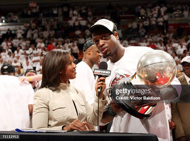 Dwyane Wade of the Miami Heat holds the Eastern Conference Championship Trophy after defeating the Detroit Pistnos in game six of the Eastern...