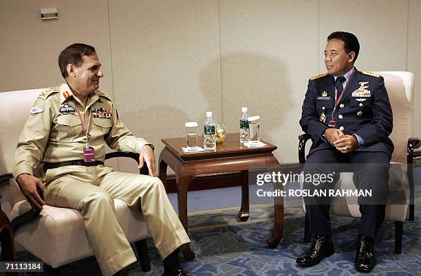 General Ehsan-ul-Haq chairman, Chiefs of staff Committee of Pakistan chats with Indonesian Air Marshal Djoko Suyanto , commander- in-chief for...