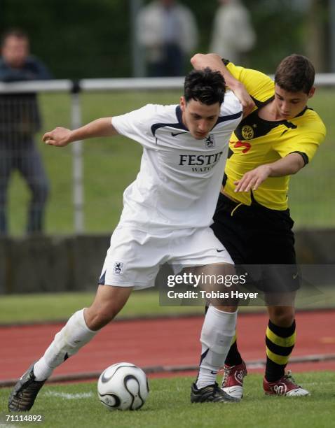 Timo Gebhardt of Munich holds off a challenge from Fabian Gotze of Dortmund during the B Juniors Championship Final between Borussia Dortmund and TSV...