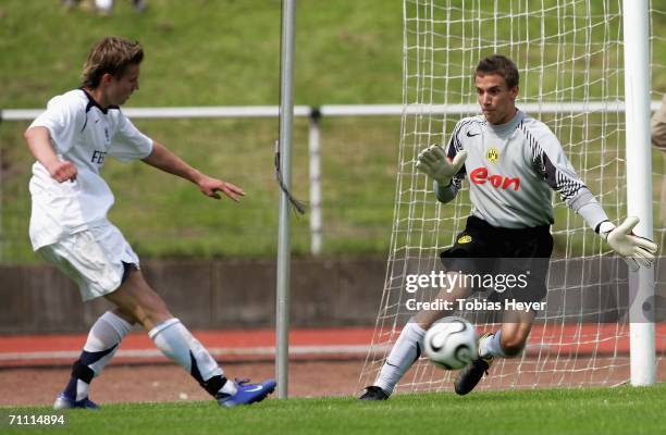 Manuel Sch?ffler of Munich takes a shot against goalkeeper Jonathan Mellwig of Dortmund during the B Juniors Championship Final between Borussia...