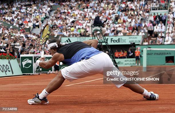 Spain's Rafael Nadal hits a return to France's Paul-Henri Mathieu on the third round of the French tennis Open at Roland Garros in Paris 03 June...