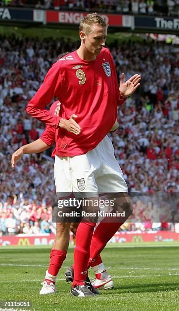 Peter Crouch of England performs his celebratory dance fter completing his hatrick and scoring his team's sixth goal during the International...