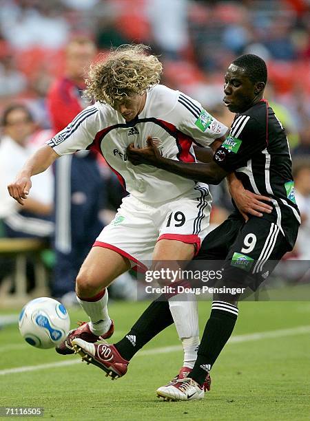 Tony Lochhead of the New England Revolution and Freddy Adu of DC United battle for the ball during MLS action on June 3 2006 at RFK Stadium in...