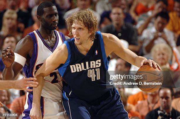Dirk Nowitzki of the Dallas Mavericks backs down against Tim Thomas of the Phoenix Suns in game six of the Western Conference Finals during the 2006...