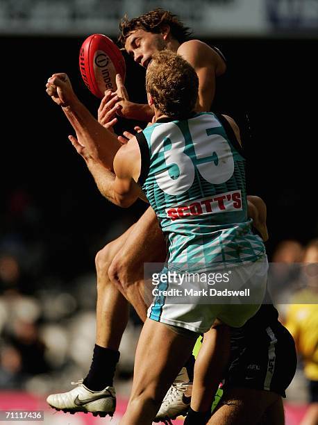 Andrew Walker of the Blues flies for a mark with Chad Cornes of the Power during the round 10 AFL match between the Carlton Blues and the Port...