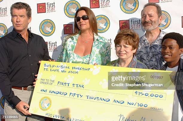 Actor Pierce Brosnan, actor Keely Shaye Smith, First Star's Maxine Clark, First Star's Peter Samuelson and actor Malcolm David Keeley hold a donation...