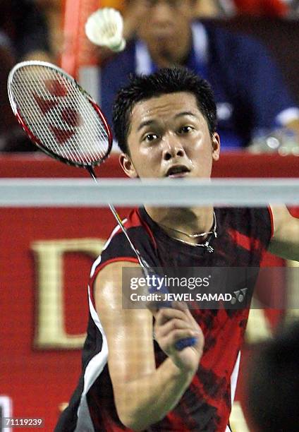 Indonesia shuttler Taufik Hidayat returns the shuttlecock to his Chinese opponent Chunlai Bao during the men single final of the Indonesia Open...