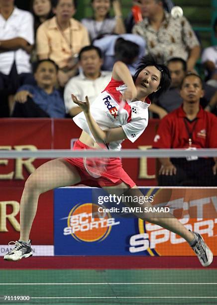 Chinese shuttler Lan Lu leaps in the air as she smashes the shuttlecock to her compatriot opponent Lin Zhu during female's single final of the...