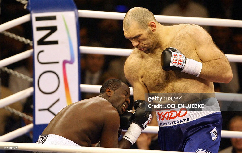 Russian boxer Nikolai Valuev (R) exchang