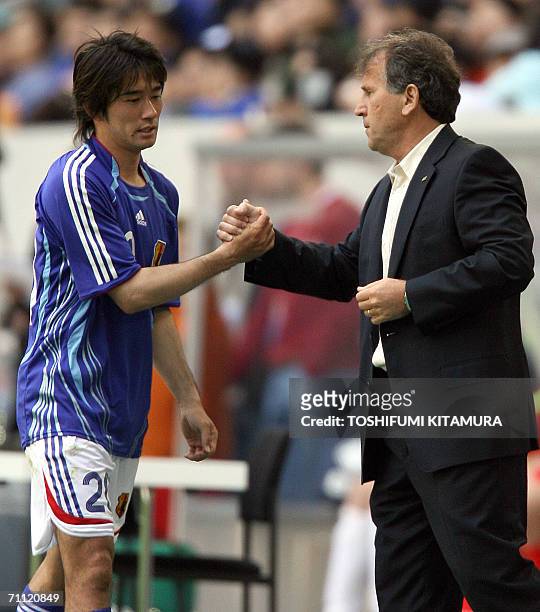 Japanese head coach Zico from Brazil congratulates forward Keiji Tamada after he was substituted during the second half of their friendly football...