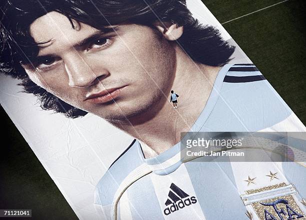 Man walks on a 60 by 15 metre big poster of Lionel Messi of Argentina at World of Sports Stadium on June 4, 2006 in Herzogenaurach, Germany