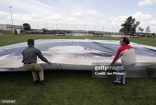 Workers unfold a 60 by 15 metre poster of Lionel Messi of Argentina at the World of Sports Stadium on June 4, 2006 in Herzogenaurach, Germany
