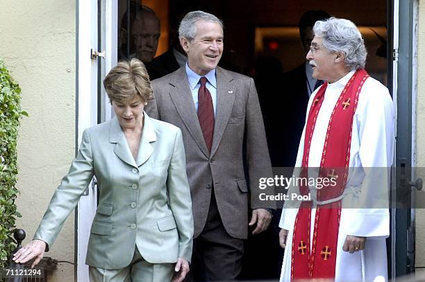 President George W. Bush leaves St. John's Episcopal Church with Rev. Luis Leon and first Lady Laura Bush after a Sunday service June 4, 2006 in...