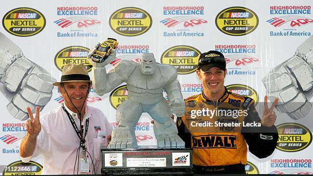 Jack Roush , team owner of Roush Racing, and his driver Matt Kenseth, driver of the DeWalt Ford, celebrate with the trophy in victory lane after...