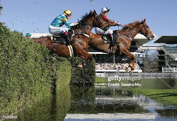 Bit of a Myth ridden by James Gillies and Just the Man ridden by Nathan Hanley clear the water jump during the Lindauer McGregor Grant Steeplechase...