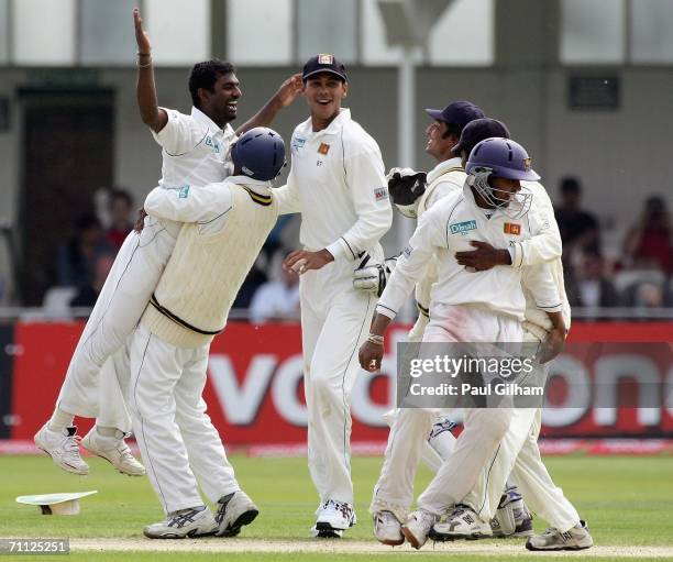 Muttiah Muralitharan of Sri Lanka celebrates with his team-mates after taking the wicket of Andrew Flintoff of England during day four of the third...