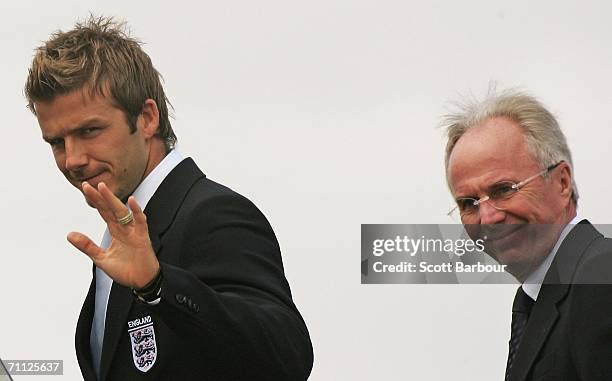 England captain David Beckham waves as he and coach Sven-Goran Eriksson board their plane at Luton Airport as the England World Cup football squad...