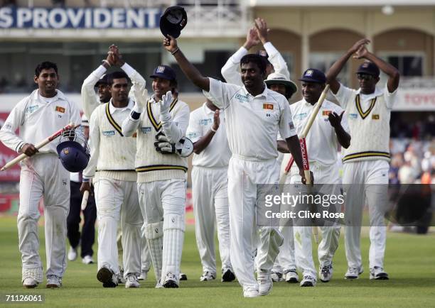 Muttiah Muralitharan of Sri Lanka celebrates his wicket hall and his team's win as he walks from the field at the end day four of the third npower...