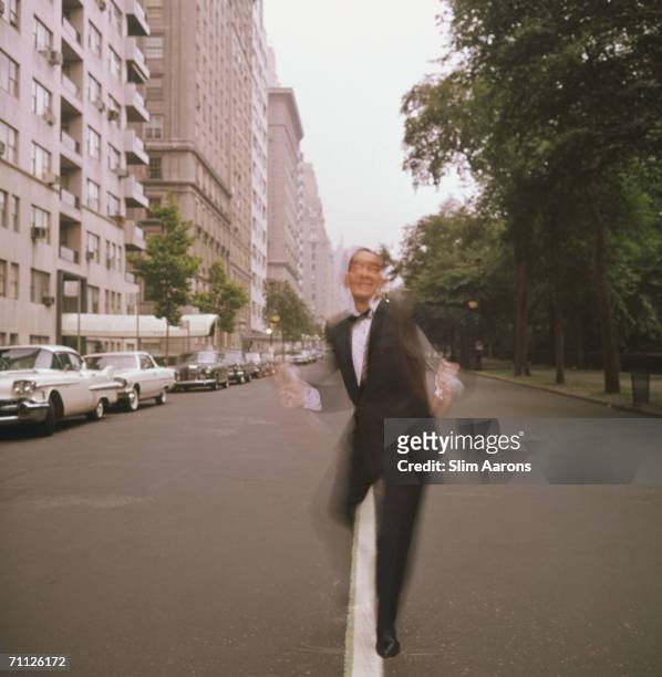 American dance instructor 'Killer' Joe Piro dances past the park in New York, July 1964.
