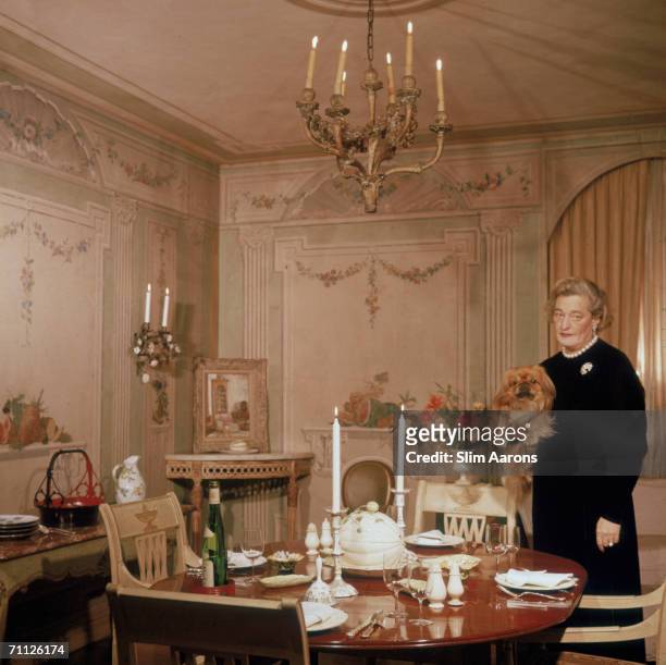 American interior decorator Sister Parish , co-founder of Parish-Hadley Associates, prepares dinner for four in New York, 1960.