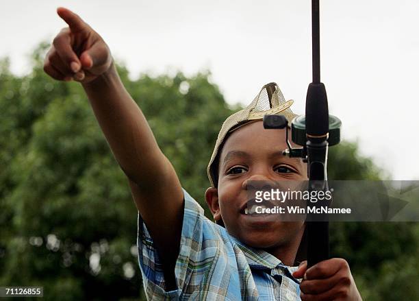 Marqueese Favors of Washington, DC says "I did it" after successfully casting his line during the "Fishing on the Mall," event to celebrate National...