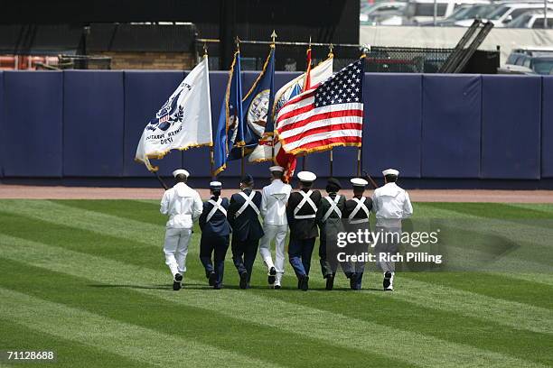 The color guard walks across the field during the game between the New York Yankees and the New York Mets at Shea Stadium in Flushing, New York on...