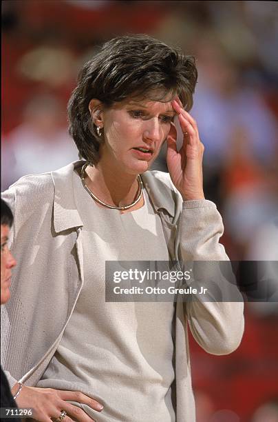 Coach Anne Donovan of the Indiana Fever thinks about the action during a game against the Seattle Storm at the Key Arena in Seattle, Washington. The...