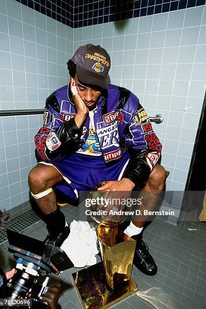 Kobe Bryant of the Los Angeles Lakers displaying the NBA championship trophy after defeating the Philadelphia 76ers in game five of the 2001 NBA...