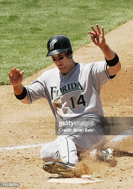 Josh Willingham of the Florida Marlins slides into home against the Colorado Rockies on June 4, 2006 at Coors Field in Denver, Colorado. The Marlins...