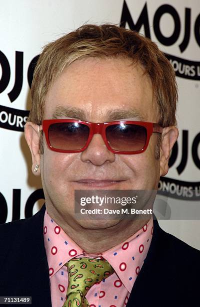 Elton John poses with his Mojo Hall of Fame award at the MOJO Honours List 2006, the music magazine's third annual awards, at Shoreditch Town Hall...